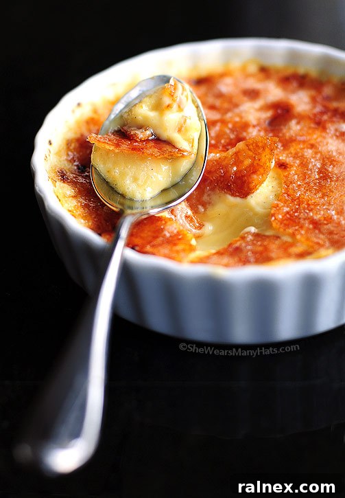Exquisite Meyer Lemon Crème Brûlée dessert, perfectly caramelized with a vibrant lemon slice