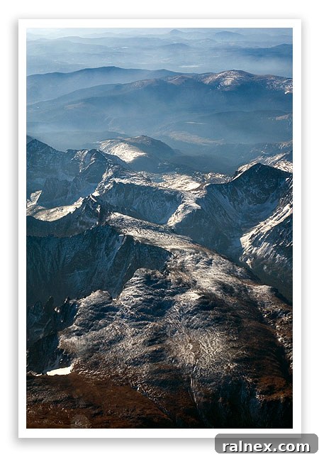 fly26 fly26 - Airplane flying close to sharp mountain peaks