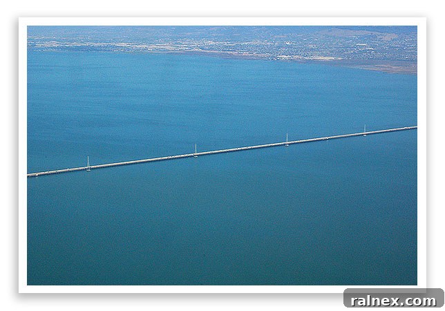 fly9 - Impressive bridge over a bay, with a tiny sailboat