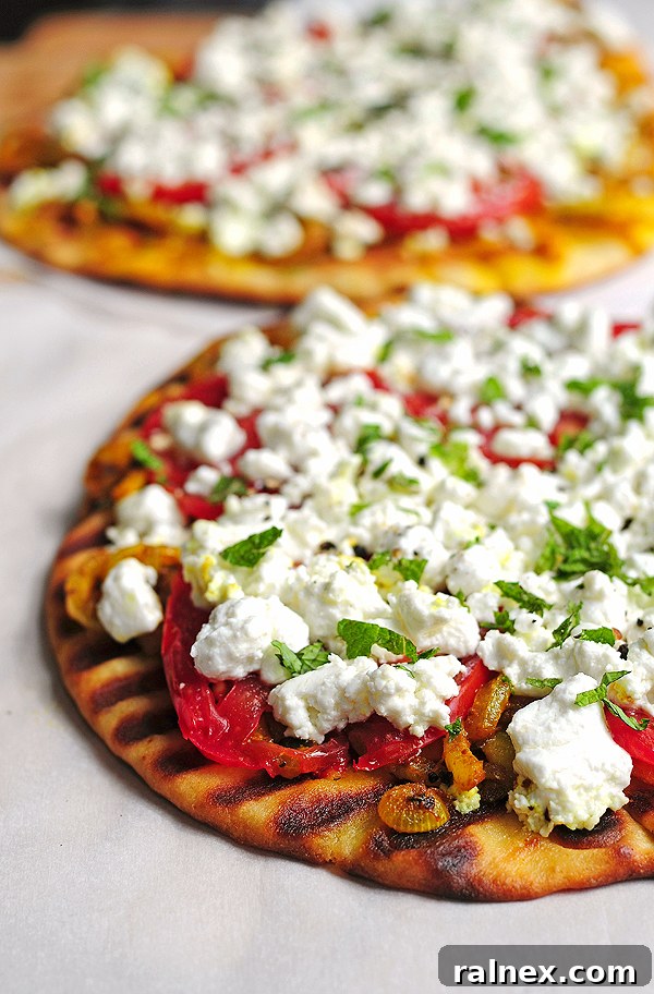 Spiced Naan with Melted Chèvre 3 Close-up of Grilled Spicy Naan with Goat Cheese, garnished with fresh mint.