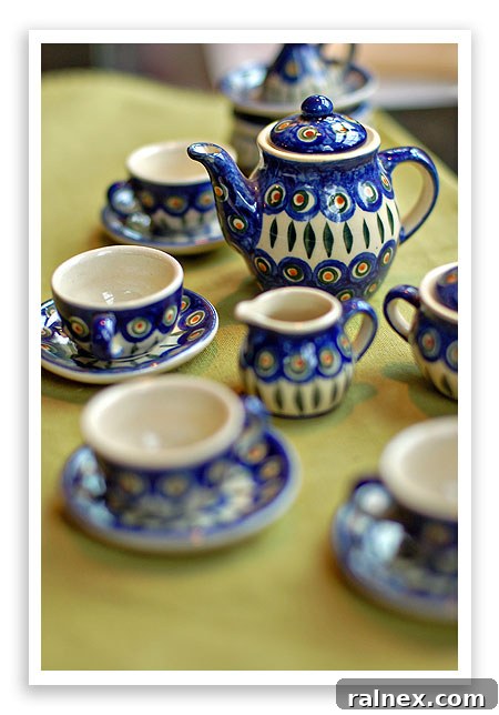 A vibrant collection of Polish Pottery mugs and bowls, arranged beautifully to show their diverse patterns and uses.