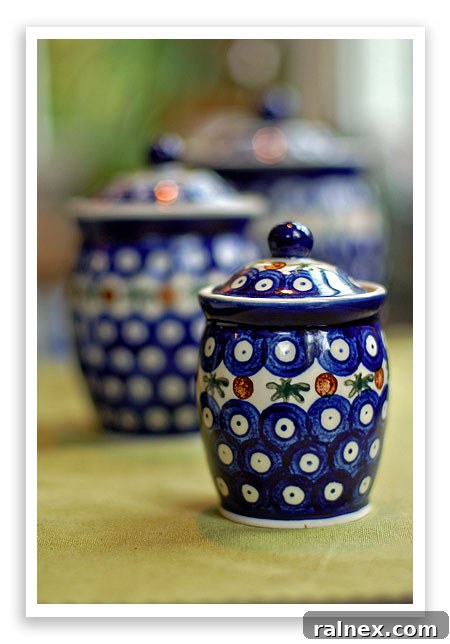 A diverse assortment of Polish Pottery plates and serving dishes, highlighting various traditional and contemporary patterns.