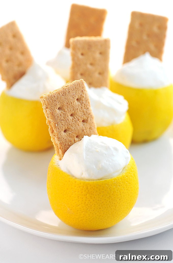 Crafting Irresistible Lemon Cups 14 Final presentation of a lemon cup filled with vibrant sorbet and garnished with fresh mint, ready to serve with flair.