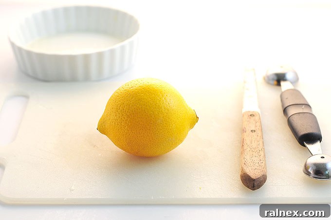 Crafting Irresistible Lemon Cups 2 Step 1: Carefully slicing a small sliver off the bottom of a lemon to create a flat, stable base.