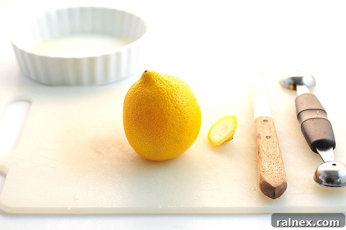 Crafting Irresistible Lemon Cups 5 Step 4: Close-up of the serrated knife effectively separating the pulp from the lemon rind, avoiding punctures.