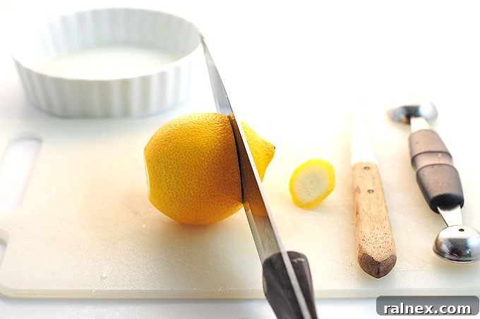 Crafting Irresistible Lemon Cups 6 Step 5: Illustrating the technique to use the serrated knife to loosen the lemon pulp from all sides.