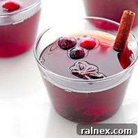 This Spiced Cranberry Hot Toddy Recipe is the perfect drink to enjoy at the end of a chilly day and will have your home smelling wonderful! | shewearsmanyhats.com