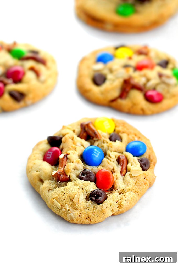 A wire rack filled with cooling, freshly baked Monster Cookies