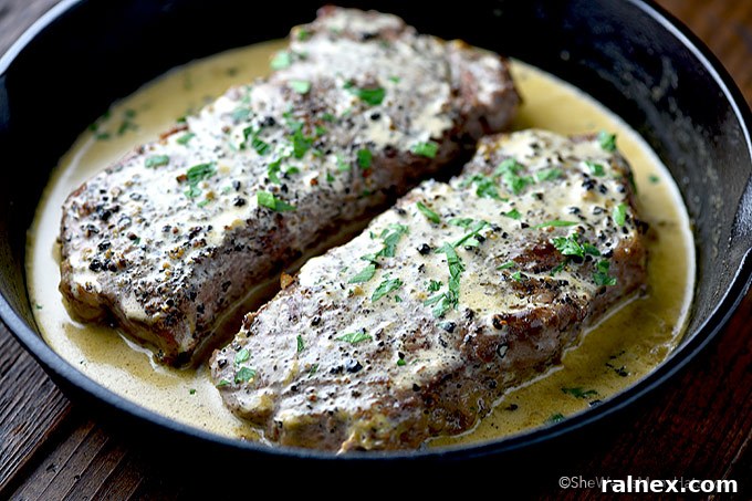 Steak au Poivre on a serving plate with green beans.