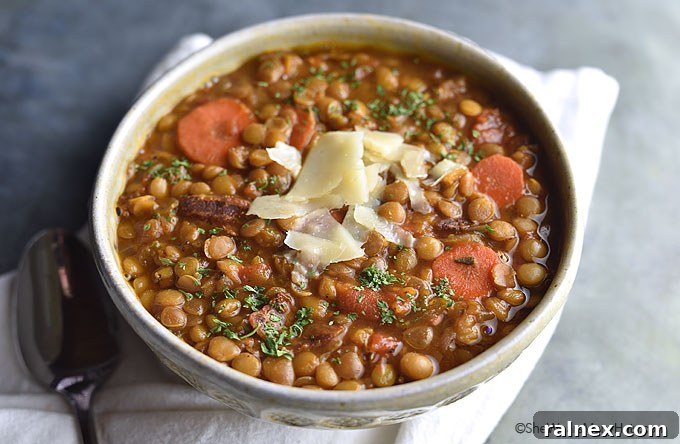 Bacon Lentil Soup garnished with fresh herbs, ready for a cozy meal.