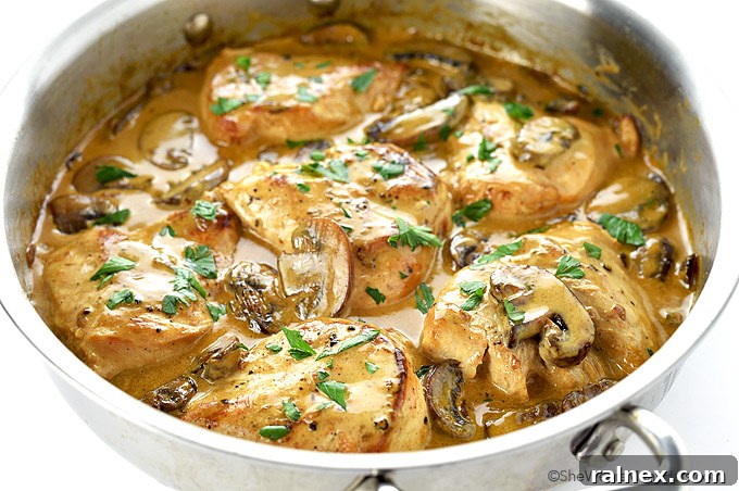 Decadent Mushroom Smothered Chicken 4 Close-up photo of a serving of Chicken Breasts with Mushroom Cream Sauce in a pan.