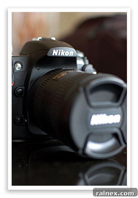 New professional camera, shiny black body and lens, ready for use